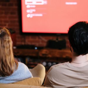 couple watching tv illustrating one need one of the top TV products for assistance.