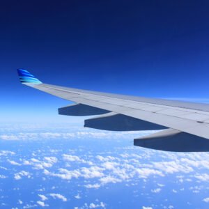 Plane wing above clouds illustrating the altitude and ear pressure it would create.